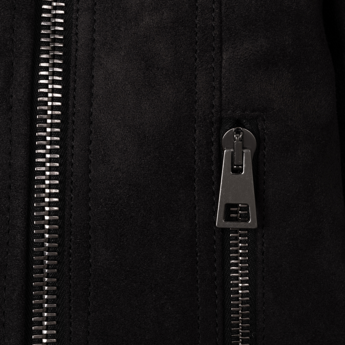 Close-up of The Diva jacket's signature gunmetal zipper pull and premium technical suede texture, highlighting precision Italian stitching