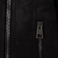 Close-up of The Diva jacket's signature gunmetal zipper pull and premium technical suede texture, highlighting precision Italian stitching