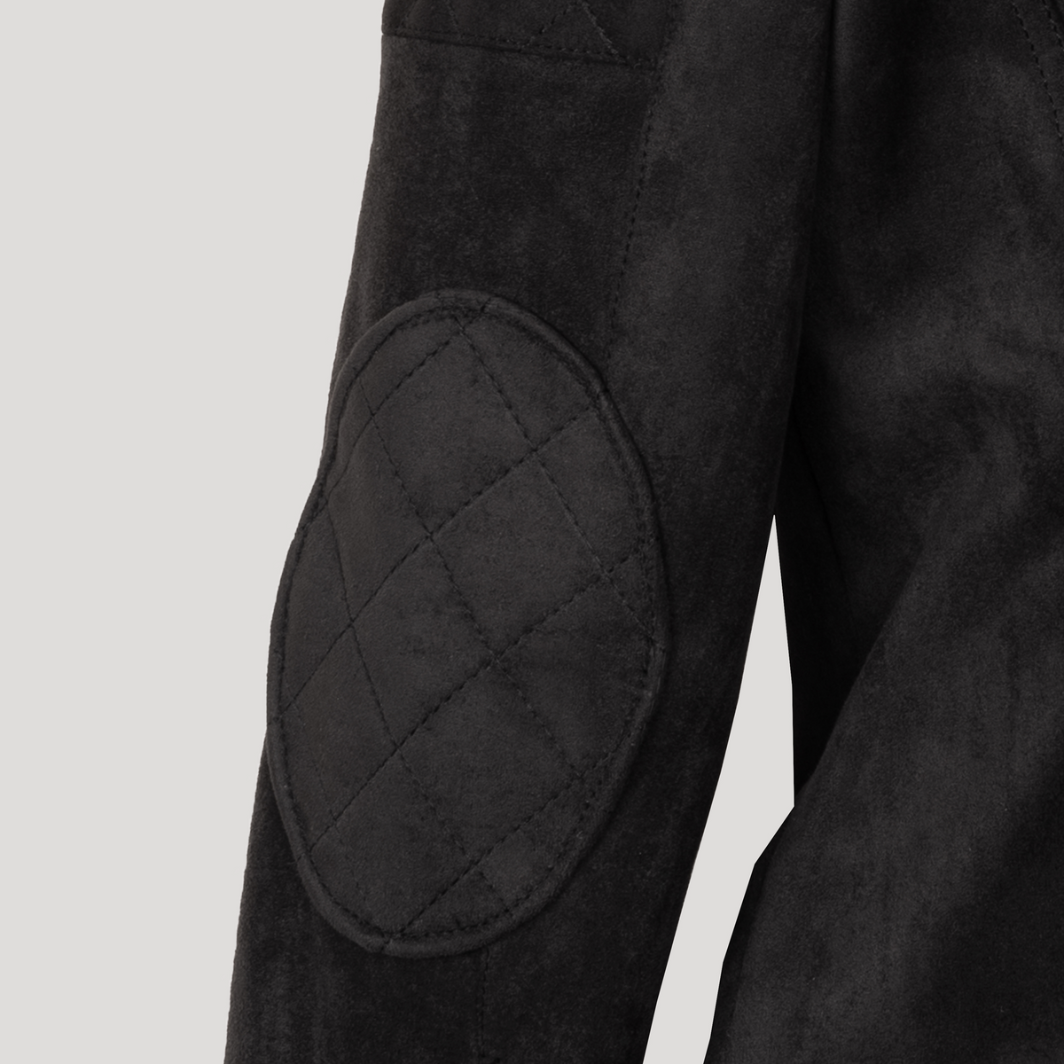 Close-up of the Diva jacket's quilted elbow patch, highlighting the soft texture and precision stitching of the technical suede