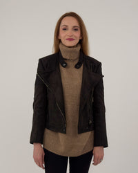 The Diva jacket in black technical suede, shown open over a high-neck tan sweater to highlight the soft, breathable Italian fabric