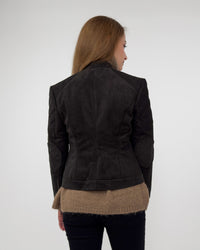 Lifestyle view from the back of the Diva jacket in black technical suede, layered over a tan knit sweater to show the soft, flexible fit